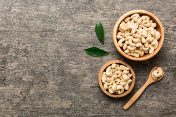 cashew nuts in wooden bowl on table background. top view. Space for text Healthy food