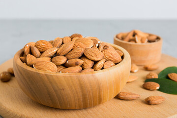 Fresh healthy Almond in bowl on colored table background. Top view