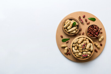 Fresh healthy peanuts in bowl on colored table background. Top view Healthy eating bertholletia concept. Super foods