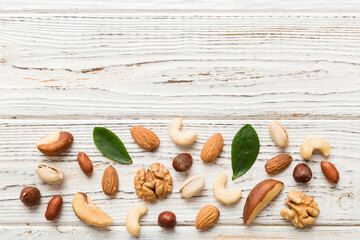 Composition of nuts , flat lay - mix hazelnuts, cashews, almonds on table background. healthy eating concepts and food background