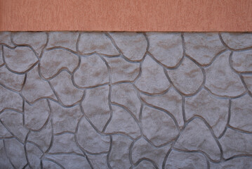 Wall facade made with concrete in rubble stone shape and stucco bark beetle