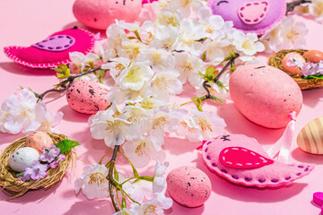 Gentle Easter composition with cherry flowers and handmade felt birds. Decorative eggs and nest