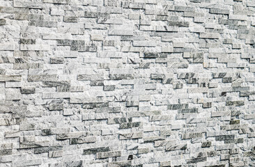 abstract stone wall made of gray marble tiles, selective focus, copy space. Wallpaper