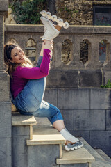 Young woman smiling while roller skating in the park