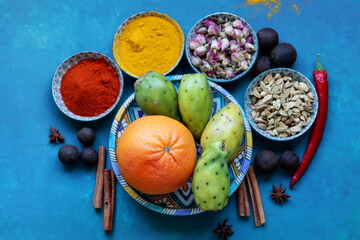 Close up photo of various spices on a table. Vivid blue background. Eating healthy concept.  