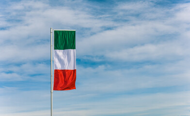 travel in italy.flag of italy on a flagpole.flag in the wind.Symbol of italy.Italian language.Travel agency.Symbol of the country.Warm country.holiday in italy.rag flag.country's national color
