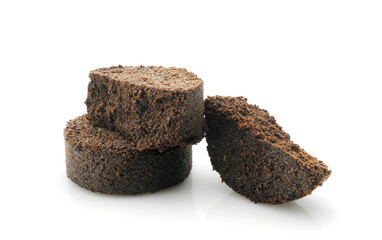 Used ground coffee tabs, waste from espresso machine isolated on white background. Natural body scrub ingredient, garden fertilizer.    
