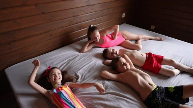 Satisfied children on vacation in swimsuits