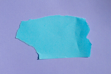 Blue torn paper background. Ripped paper on a purple background with copy space.