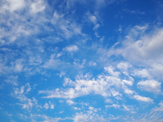 The blue sky and white clouds are natural beauty. The sky with white clouds scattered during the summer day.
