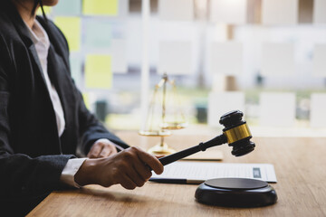 Female lawyer working at desk in law office. Legal counsel and legal justice concept.