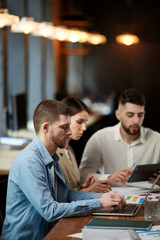 Serious, motivated employees, collegase sitting at table and working on new project. Business meeting, conference in office. Concept of business, teamwork, career development, brainstorming