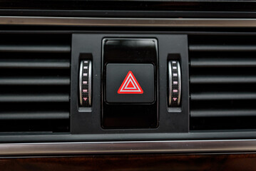 Emergency stop button of the car. Dashboard detail with emergency hazard light signal button. Air...