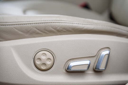 Car electronic driver seat adjustment. Seat electronic switch button in a modern premium car. Seat memory option. Interior of new clean expensive car. Seats with nappa leather. Details closeup.