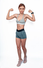 Fototapeta premium Slender female body pumped muscles. Sporty woman in shorts and top. Bodybuilding. Healthy Lifestyle.