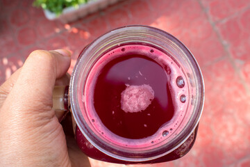 Healthy organic and homemade beetroot juice in jar in hand. weight loss and healthy lifestyle...