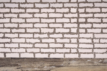 White brick facade wall without plaster. Empty background of stained brickwork construction