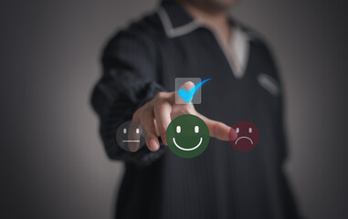 Concept of satisfaction and customer service. : Business man use his finger to touching or pressing the virtual screen the smiley happy face with star to show satisfaction with the service or give rat