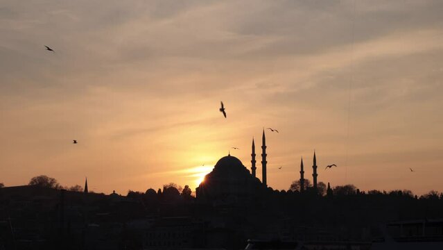 Islamic background video. Suleymaniye Mosque and seagulls at sunset. Travel to Istanbul or Ramadan or Islamic 4K footage.