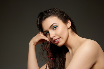 Obraz premium Half-length portrait of young emotional beautiful girl looking at camera isolated over grey background. Beauty, fashion, style, fun and joy concept