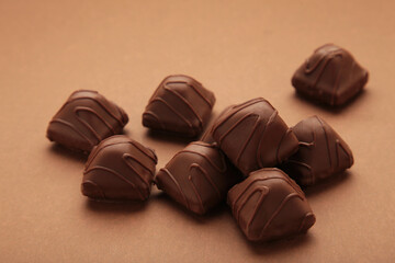 Chocolate candies on brown background. Top view