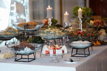 Luxury catering wedding buffet with different food snacks and beverages on table. Eating Concept. Restaurant christmas decoration.
