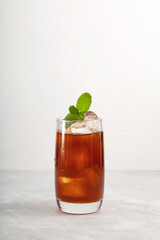 Iced Tamarind drink or Tamarind ice tea in tall glass. Refreshing summer mexican drink with natural...