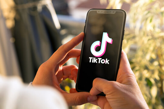 Tiktok on mobile phone Screen. Young woman holding a Smart Phone with Tik Tok app. ROSARIO, ARGENTINA -MARCH 15, 2023.