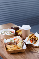 Greek food in a fast food restaurant. Gyros sandwich, souvlaki meat and pita bread served with tzatziki sauce and fries in a disposable paper dishware