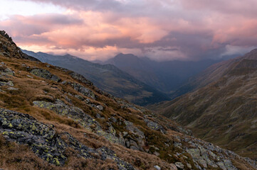 Beautiful autumn view of mountains with setting sun and colorful sky
in the austrian alps in the hohe tauern mountains