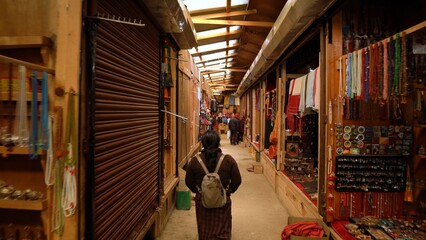 People walking inside the narrow shopping passage in Thimphu, Bhutan