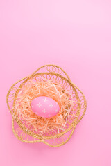 Happy Easter holiday greeting card concept. Colorful Easter Eggs on pastel pink background. Flat lay, top view, copy space.