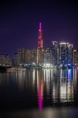 Fototapeta premium Illuminated skyscrapers near river at night