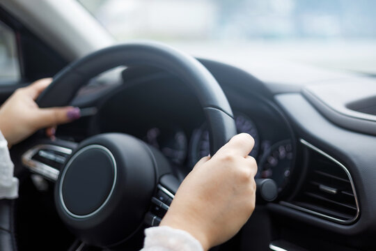 Close Up Hands Of Woman Driving A Car..