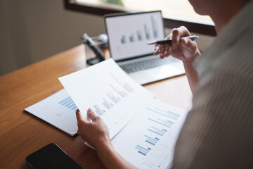 Woman calculating monthly expenses, taxes and interest calculate at home..