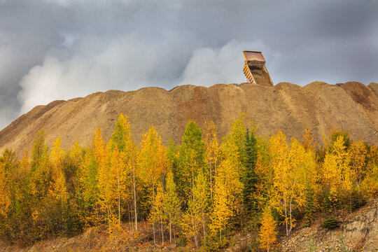 Gold mining in Canada's Yukon Territory; heavy truck is unloading on a dump with mine tailings
