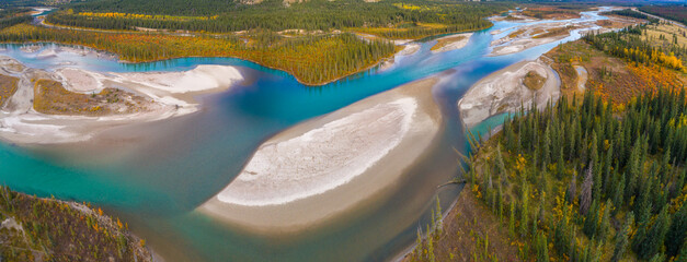 Aerial view in panorama format of a braiding river with sand banks in the Rocky Mountains, Canada