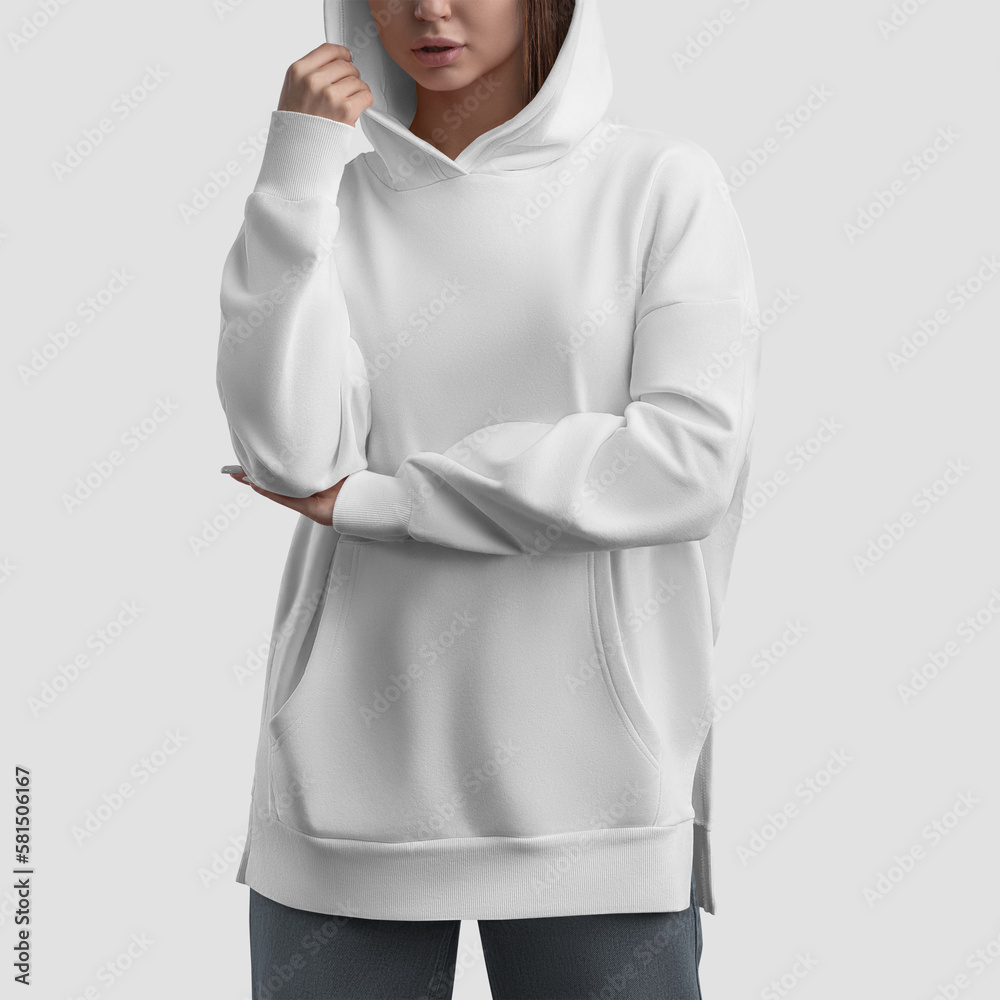 Wall mural Mockup of a white long hoodie with a pocket, an oversized shirt on a girl, a longsleeve with side slits, for design. - Wall murals