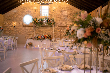 Romantic boho main table. Wedding decor with dried flowers floristry, stumps, and candles, boho style. Pampas grass