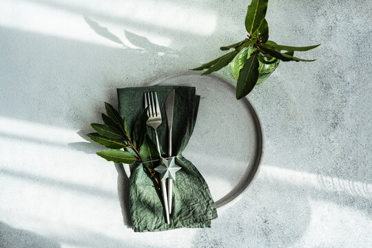 Table setting with fresh green leaves of Laurel