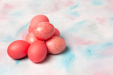 Pink easter eggs on watercolor cloud background