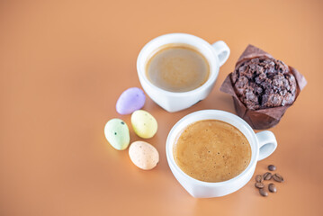 Hot coffee drink in a white cup with fresh sweet baking