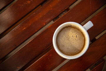 cup of coffee on the table outdoor and flowers primrose multicolored copy space food background rustic top view