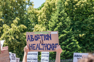 Protests holding pro-abortion signs at demonstration in response to the Supreme Court Dobbs ruling...