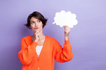 Photo of clever minded person hand touch chin look empty space hold cloud shape card isolated on violet color background