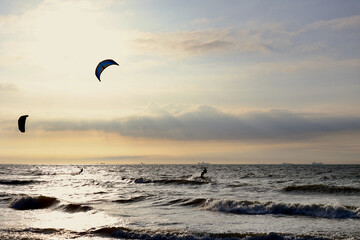 Kitesurfing in the evening at a Dutch beach on a windy spring day. The north sea near Wassenaar, The Netherlands. 