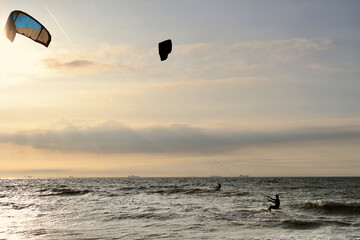 Kitesurfing in the evening at a Dutch beach on a windy spring day. The north sea near Wassenaar, The Netherlands. 