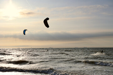 Kitesurfing in the evening at a Dutch beach on a windy spring day. The north sea near Wassenaar, The Netherlands. 