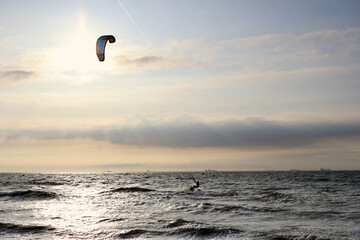 Kitesurfing in the evening at a Dutch beach on a windy spring day. The north sea near Wassenaar, The Netherlands. 