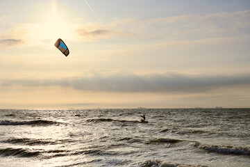 Kitesurfing in the evening at a Dutch beach on a windy spring day. The north sea near Wassenaar, The Netherlands. 